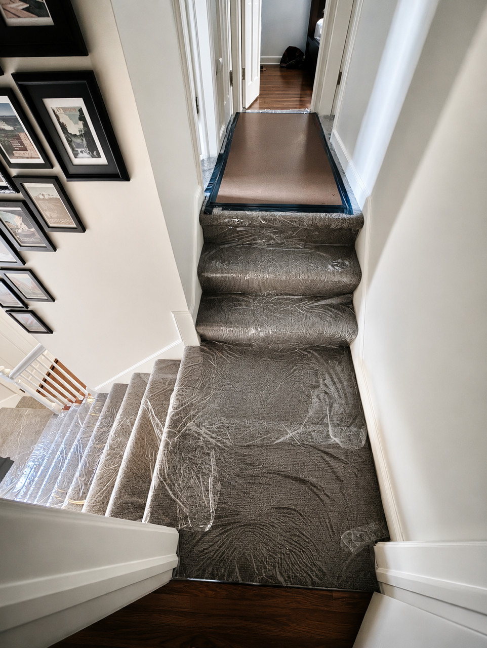 Carpeted stairs and landing covered with clear protective film.